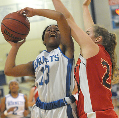 Selena Martin (13) powers up a shot over a Cabot defender. (Photo by Kevin Nagle)