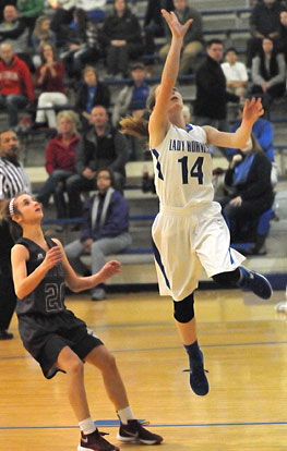 Meagan Chism (14) puts up a shot in front of Benton's Kati Morrow. (Photo by Kevin Nagle)