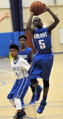 Bryant White's Kaylon Thurston takes a shot off a drive into the lane as Bryant Blue's Brandon Weems blocks out. (Photo by Kevin Nagle)