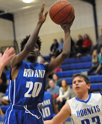 Bryant White's Colby Washington (20) goes up for a shot in front of Bryant Blue's Brayden Knight (33). (Photo by Kevin Nagle)