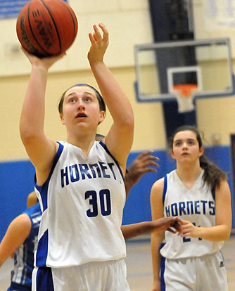 Bryant Blue's Cali Rogers (30) eyes a free throw as teammate Natalie Harllee (24) looks on. (photo by Kevin Nagle)