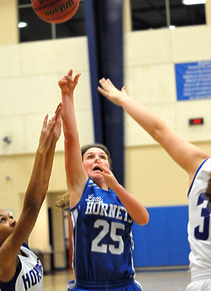 Bryant White's Madalynn Thompson launches a shot in traffic. (Photo by Kevin Nagle)