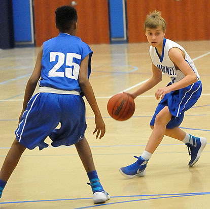 Bryant Blue's Jordan Phillips looks for room to drive around Bryant White's Keyshawn Scott. (Photo by Kevin Nagle)