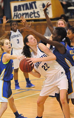 Truli Bates (22) gets double-teamed in the post area as teammate Essence Williams (3) tries to get her attention for a pass out. (Photo by Kevin Nagle)