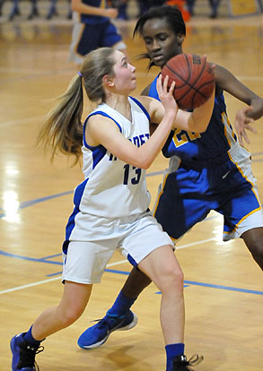 Casey Welch (13) tries to find room for a shot around a North Little Rock defender. (Photo by Kevin Nagle)