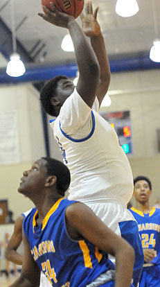 KaJuan Robinson tries to score in a crowd inside. (photo by Kevin Nagle)
