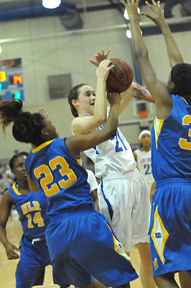 Mary Catherine Selig (21) yanks down one of her 10 rebounds in Monday's game. (Photo by Kevin Nagle)