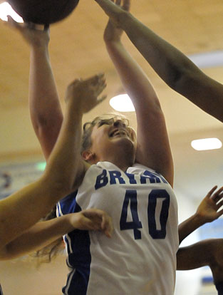 Morgan Walters battles to get a shot away under the boards. (Photo by Kevin Nagle)