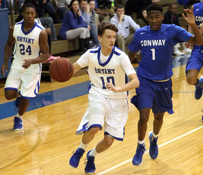 Garrett Coward (10) looks for room to drive as teammate Marvin Moody and Conway's Prentice Mullins trail the play. (Photo by Rick Nation)