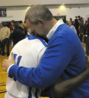 Senior Kevin Hunt and Bryant coach Mike Abrahamson hug after Tuesday's Saline County Shootout win. (Photo by Kevin Nagle)