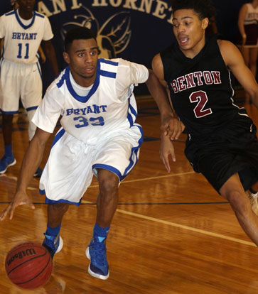 Romen Martin (33) brings the ball up under defensive pressure from Benton's Clay Anderson (2). (Photo by Rick Nation)