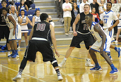 Marvin Moody (24), Braylon Steen (25) and Romen Martin apply defense as Benton's Cason Maertens (10) looks for an opening. (Photo by Kevin Nagle)