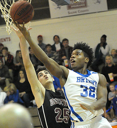 Lowell Washington (32) puts up a shot inside after driving around Benton's Jake Scoggins. (Photo by Kevin Nagle)