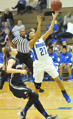 Destiny Martin (21) gets past Greenwood's Kyiah Julian on the way to the hoop. (Photo by Kevin Nagle)