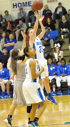 Kendall Rogers (23) takes a shot in front of teammate Raven Loveless (2) and Mount St. Mary's Kara Rogers. (Photo by Kevin Nagle)