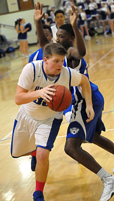 Blaise Smith tries to drive around a Conway White defender. (Photo by Kevin Nagle)