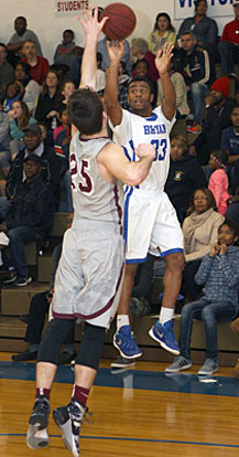 Romen Martin (33) lets a 3-point shot fly over Siloam Springs defender Carlson Wakefield (25). (Photo by Rick Nation)