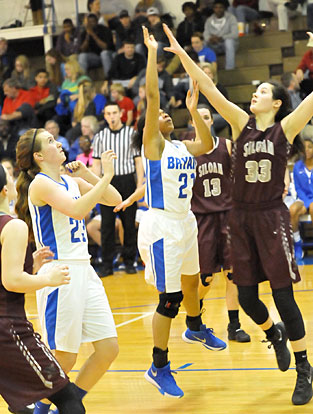 Destiny Martin tries to get a shot over a Siloam Springs defender as Kendal Rogers (23) looks to get into rebounding position. (Photo by Kevin Nagle)