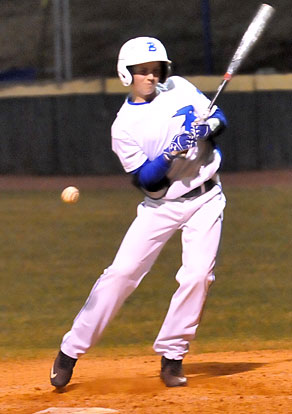 Freshman Logan Chambers recoils after taking a pitch in the side. (Photo by Kevin Nagle)