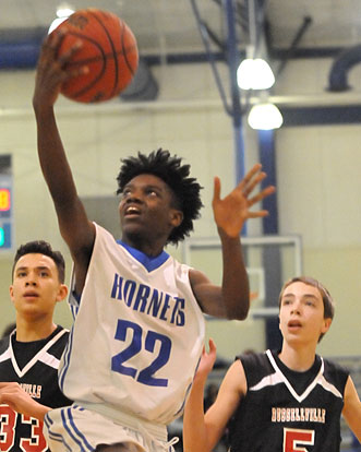 O.J. Newborn (22) splits a pair of Russellville defenders on the way to the hoop. (Photo by Kevin Nagle)