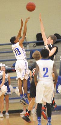 Darrick Rose (13) fires a shot over a Russellville defender. (Photo by Kevin Nagle)