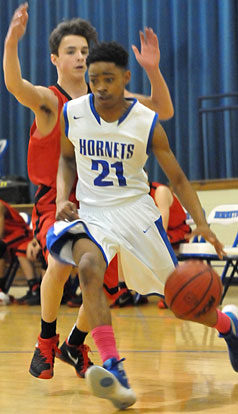 Josh Robinson (21) drives around a Russellville defender. (Photo by Kevin Nagle)
