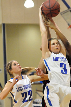 Rachel Studdard (3) pulls down a key rebound as teammate Lauren Burnett arrives to help. (Photo by Kevin Nagle)