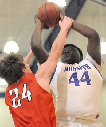 Kajuan Robinson (44) gets fouled on his shot by Russellville's Langston Parker. (Photo by Kevin Nagle)