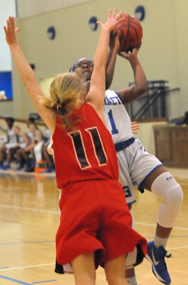 Tierra Trotter (1) tries to finish a drive to the basket. (Photo by Kevin Nagle)