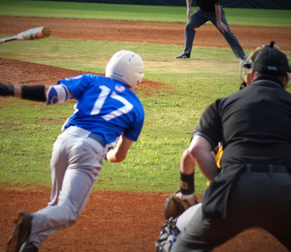 Jake East heads up the first base line after hitting a pitch to the right side. (Photo courtesy of Paul Dotson)