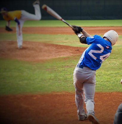 Jordan Gentry follows through on a swing against Catholic's Dylan Thompson. (Photo courtesy of Paul Dotson)