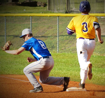 First baseman Aaron Orender takes a throw to retire Little Rock Catholic's Ben Bryles in the third inning of Friday's game. (Photo courtesy of Paul Dotson)