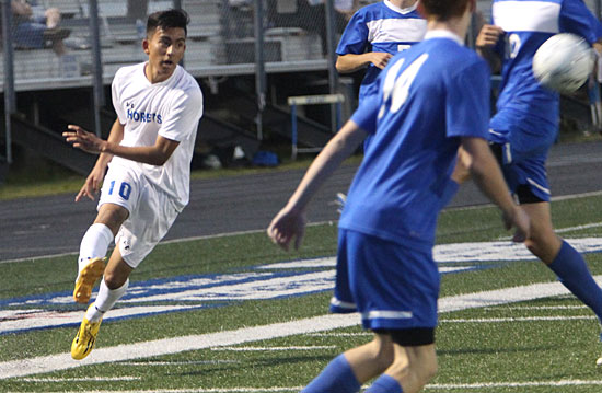 Jhorman Cruz (10) passes the ball through three Conway defenders. (Photo by Rick Nation)