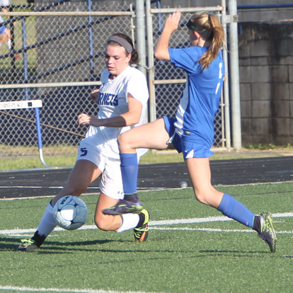 Kendall Selig works to control the ball against a Conway defender. (Photo by Rick Nation)