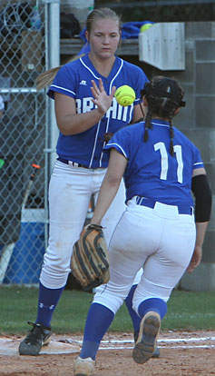 Mallory Theel takes a throw at first base from teammate Macey Jaramillo. (Photo by Rick Nation)