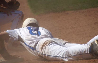 Aaron Orender clings to third base after sliding in safely on a close play. (Photo courtesy of Paul Dotson)