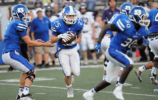 Seth Tucker takes a handoff from quarterback Beaux Bonvillain as Jeremiah Long (30) and Zak Kemp (51) provide interference. (Photo by Kevin Nagle)