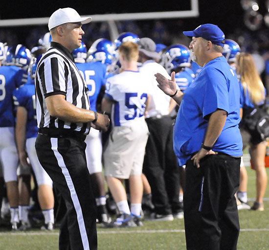 Bryant head coach Buck James talks to the official about a call that went against the Hornets. (Photo by Kevin Nagle)