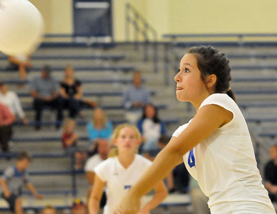 Olivia German (4) returns a serve as teammate Jill Colclasure (7) looks on. (Photo by Kevin Nagle)