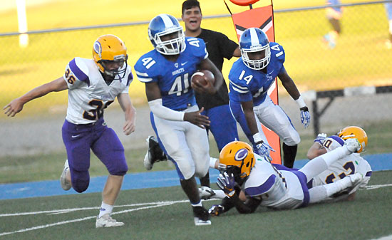 LaTavion Scott (41) cuts back through Catholic defenders off a block by Brandon Murray (14). (Photo by Kevin Nagle)