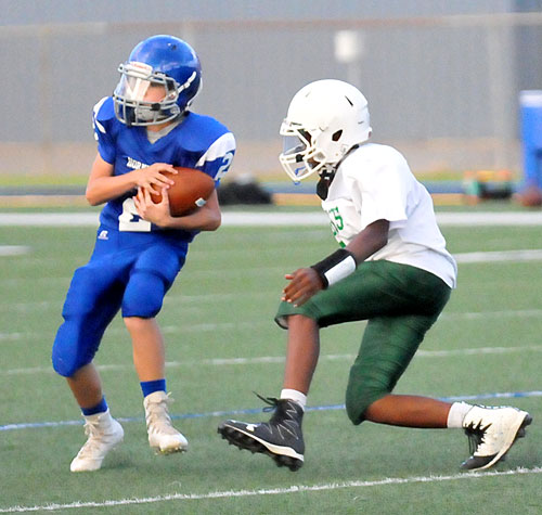 Austin Schroeder hauls in a pass in front of a Forest Heights defender. (Photo by Kevin Nagle)