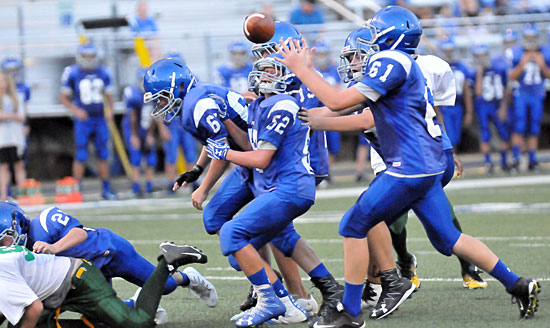 Will Heathcote (61), flanked by teammate Brayden Godwin, grabs an errant pass off a bad snap on his way into the end zone. (Photo by Kevin Nagle)