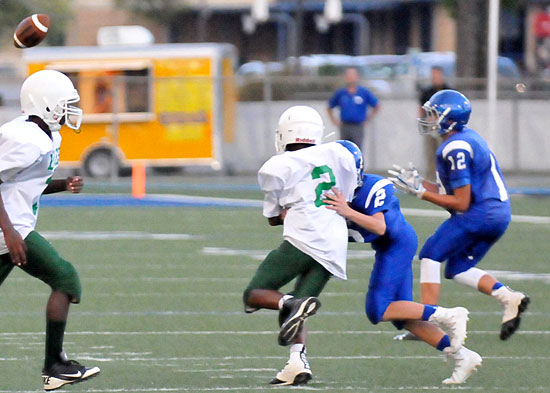 Hayden Schrader (12) prepares to catch a screen pass as Austin Schroeder clears the way with a block on Forest Heights' James Jordan. (Photo by Kevin Nagle)