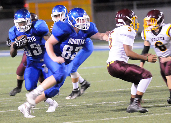 Ahmad Adams (33) follows the blocking of Tanner Wilson (83) as he turns upfield. (Photo by Kevin Nagle)