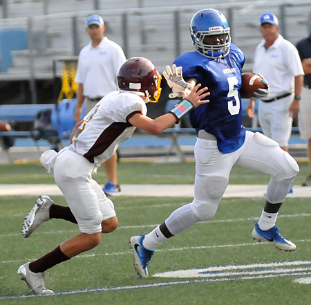 Myles Aldrige (5) applies a stiff-arm as he turns the corner against Lake Hamilton Thursday night. (Photo by Kevin Nagle)