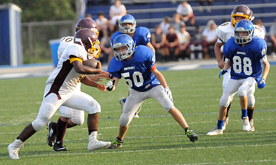 Bryant White's Chance Clendening (50) and Clay Curtis (88) set up to stop Lake Hamilton's Carlos Brewer (4). (Photo by Kevin Nagle)