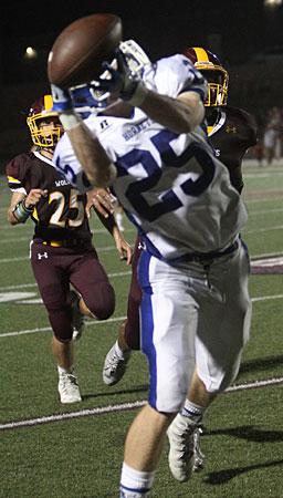 Seth Tucker hauls in a long pass from Ren Hefley that set up a touchdown early in the second half. (Photo by Rick Nation)