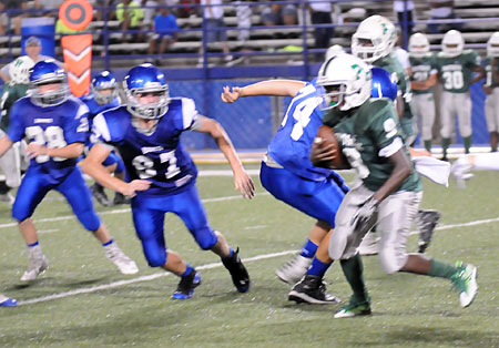 Bethel's Parker Elswick (74), Baker Gray (87) and Noah Davis (28) pursue Pulaski Heights' Jeremiah Davis. (Photo by Kevin Nagle)