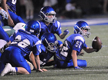 Brayden Godwin (52) shows the official he has the ball after recovering a fumble. (Photo by Kevin Nagle)