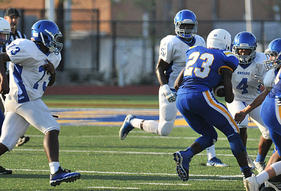 Gavin Bronson (73), Myles Aldrige (5) and Connor Coleman help hem in the ball carrier. (Photo by Kevin Nagle)